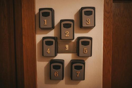 a bunch of switches on a wall with numbers at Casa di Franz in Vigo di Fassa