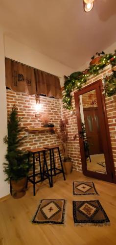 a room with a table and a brick wall at Relax Inn in Korçë