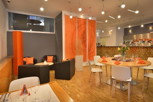 a dining room with a table and chairs at Omnia Hotel Relax & Wellness in Janske Lazne