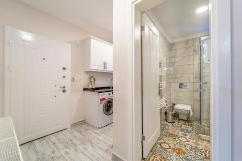 a kitchen with a washer and dryer in a room at Nakas Suites in Fethiye