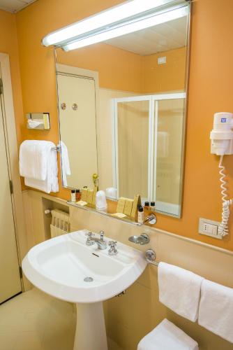 a bathroom with a sink and a large mirror at Hotel Villa La Principessa in Lucca