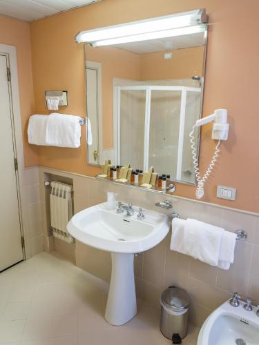 a bathroom with a sink and a mirror at Hotel Villa La Principessa in Lucca