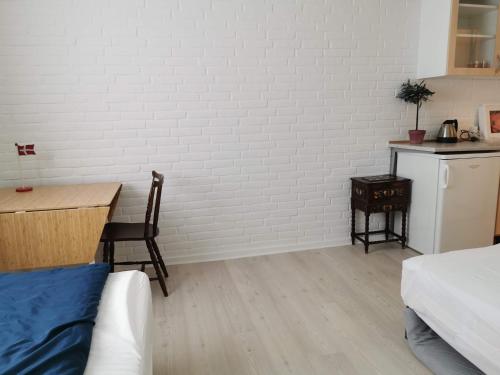 a room with a table and a white brick wall at 4 minute walk to LEGO House - n4 in Billund