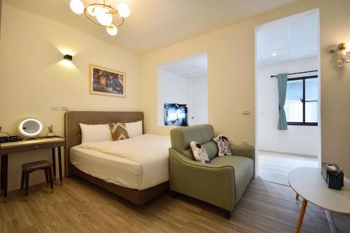 a bedroom with a bed and a chair at Full house in Taitung City