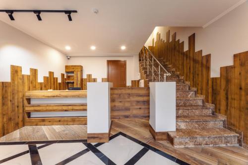 a lobby with wooden stairs and wooden walls at 10 KEYS Boutique Hotel in Borjomi