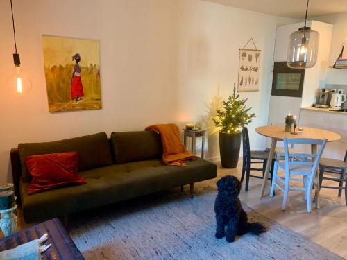 a living room with a green couch and a table at Appartement Le Ponteil in Les Deux Alpes