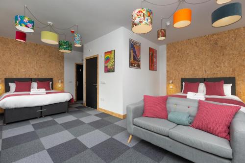 a bedroom with two beds and a couch and a bed at On The Walk in Edinburgh