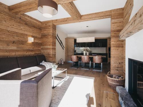 a living room with a couch and a fireplace at VAYA Terrazena Serfaus inklusive Super Sommer Card in Serfaus