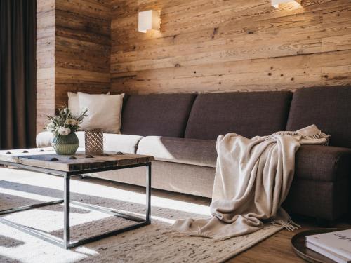 a living room with a couch and a table at VAYA Terrazena Serfaus inklusive Super Sommer Card in Serfaus