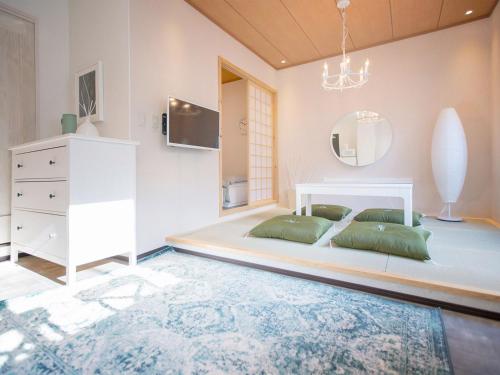 a bedroom with a white bed and a mirror at Tsubame Hotel Asakusabashi 3 minutes walk from Asakusabashi Station Near Asakusa, Akihabara, and Ueno Cooking utensils and kitchen washing machine available Direct access to Haneda and Narita airports in Tokyo