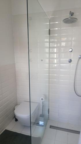 a bathroom with a toilet and a glass shower at Tiny suite with private bathroom - Bairro Alto in Lisbon