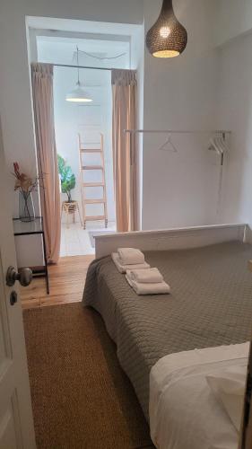 a bedroom with a bed with towels on it at Tiny suite with private bathroom - Bairro Alto in Lisbon