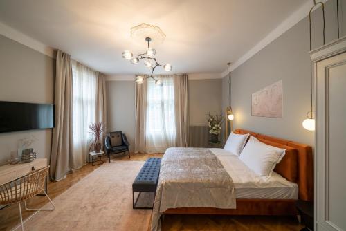 a hotel room with a large bed and a television at Nest in Győr
