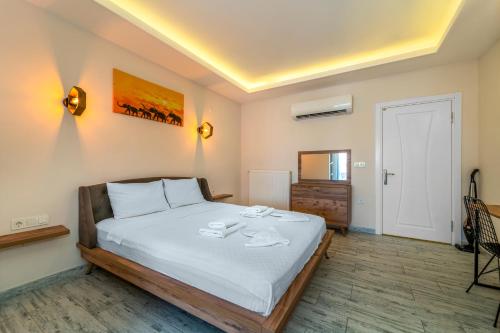 a bedroom with a bed with two towels on it at Nakas Suites in Fethiye
