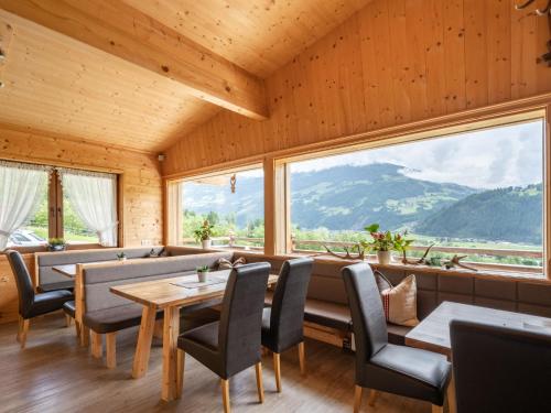 a restaurant with tables and chairs and large windows at Apartment Talbach by Interhome in Laimach