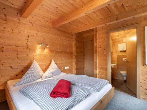 a bedroom with a bed in a wooden room at Apartment Talbach by Interhome in Laimach