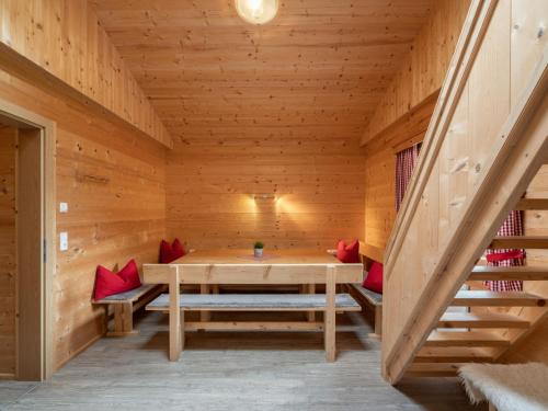 a wooden sauna with a wooden table and benches at Apartment Talbach by Interhome in Laimach