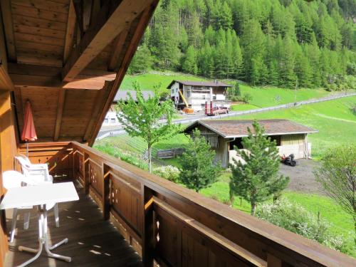a balcony of a cabin with a view of a house at Apartment Anemone - SOE710 by Interhome in Sölden