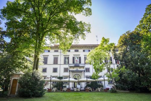 a large white building with trees in front of it at Hotel Villa La Principessa in Lucca