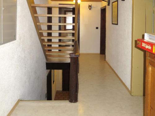 a stairway with a wooden rail and a stair case at Holiday Home Jagdhaus Strengen by Interhome in Oberriefen