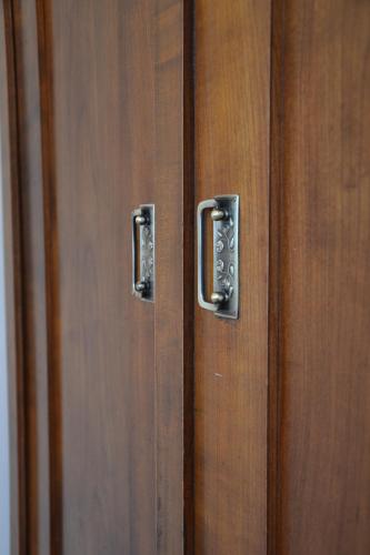 a wooden door with two metal handles on it at Guesthouse Bistra in Vrhnika