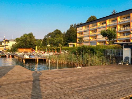 a building with a dock next to a marina at Apartment Seecorso - VEL205 by Interhome in Velden am Wörthersee