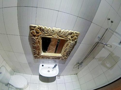a bathroom with a sink and a mirror on the wall at My Homestay Yogyakarta in Jetis