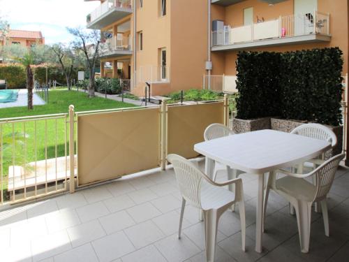 a patio with a white table and chairs on a balcony at Apartment Il Piccolo by Interhome in Toscolano Maderno