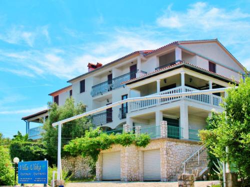 a large white building with balconies and trees at Apartment Ulika by Interhome in Ravni