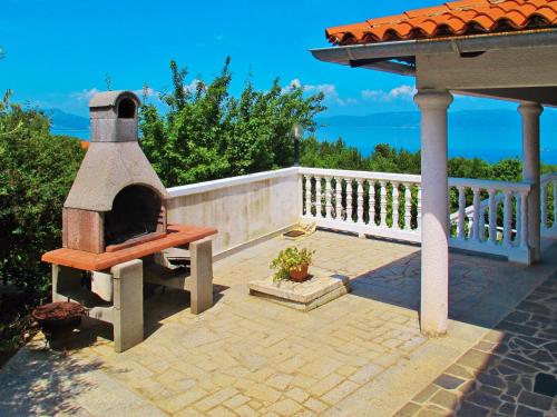 a outdoor pizza oven sitting on a patio at Apartment Ulika by Interhome in Ravni