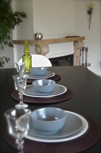 a table with plates and bowls and glasses on it at Yeti Lux - Family Garden Lodge in Garmisch-Partenkirchen