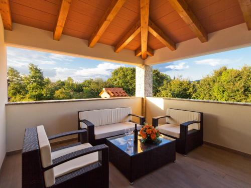 a patio with two chairs and a table on a balcony at Holiday Home Jadran - LBN310 by Interhome in Nedeščina