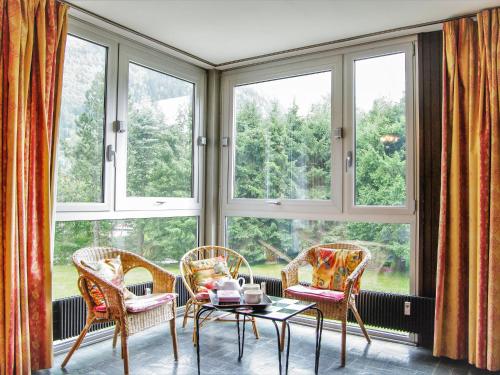 a room with three chairs and a table in front of a window at Apartment Arve 1 et 2-1 by Interhome in Chamonix