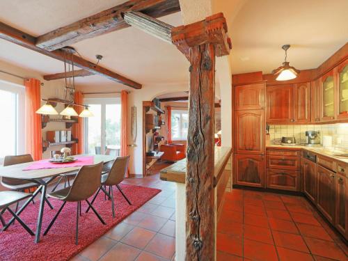 a kitchen with a table and chairs in a room at Apartment Bodmen A by Interhome in Zermatt