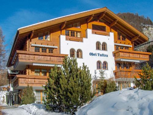 a large apartment building in the winter with snow at Apartment Obri Tuftra-4 by Interhome in Zermatt