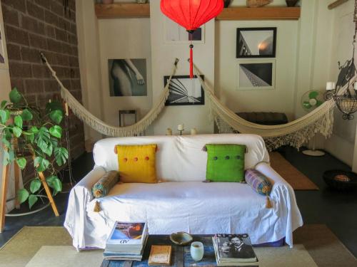 een woonkamer met een witte bank en kleurrijke kussens bij Holiday Home Campanella by Interhome in Serravalle dʼAsti