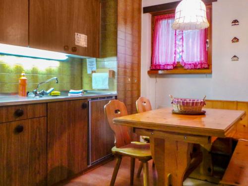ツェルマットにあるApartment Memory by Interhomeのキッチン(木製テーブル、椅子、シンク付)