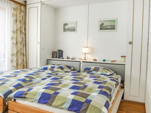 a bedroom with a bed with a blue at Apartment Milihaus A by Interhome in Zermatt