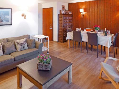 a living room with a couch and a table at Apartment Cransalpin Apt- 11 - Secteur 1 by Interhome in Vermala