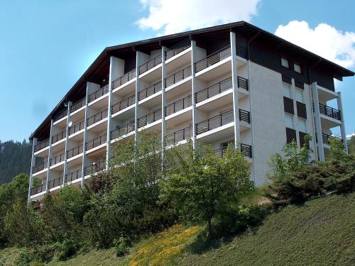 a large building on top of a hill at Apartment Armorial Est Apt- 72 by Interhome in Vermala