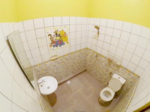 a small bathroom with a toilet and a sink at My Homestay Yogyakarta in Jetis