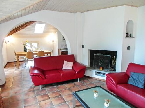 - un salon avec deux chaises rouges et une cheminée dans l'établissement Apartment Appartamento Tazzino by Interhome, à Locarno