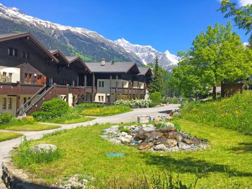 a house in the mountains with a stream in the yard at Apartment Aragon B48 by Interhome in Ernen