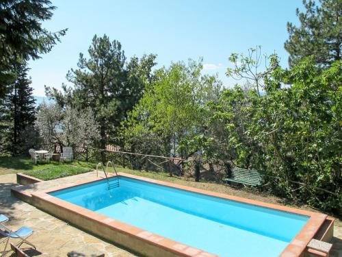 a swimming pool in a yard with trees at Holiday Home Belvedere-1 by Interhome in Pulicciano
