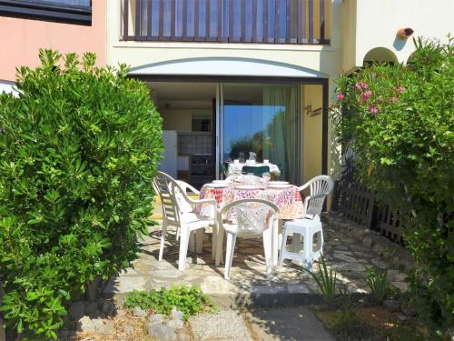 a table and chairs sitting on a patio at Apartment Les Eaux Vives 1 & 2-7 by Interhome in Saint Pierre La Mer