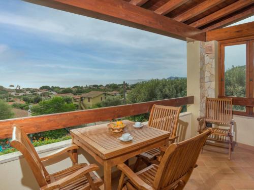 a wooden table and chairs on a balcony at Apartment Appartamento Doria - REI186 by Interhome in Monte Nai