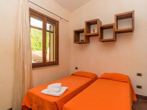 two twin beds in a room with a window at Apartment Appartamento Doria - REI186 by Interhome in Monte Nai