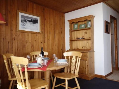 a dining room with a wooden table and chairs at Apartment La Grande Casse - Lavachet-3 by Interhome in Tignes