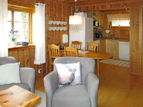 a kitchen with a table and a chair with a deer pillow at Chalet Målsnes - FJS015 by Interhome in Balestrand