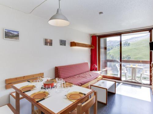 une salle à manger avec une table et un canapé dans l'établissement Apartment Pegase Phenix-15 by Interhome, au Corbier